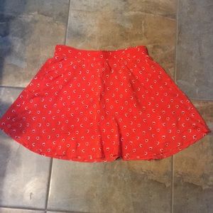 Skirt size large. Orange with violet heart pattern